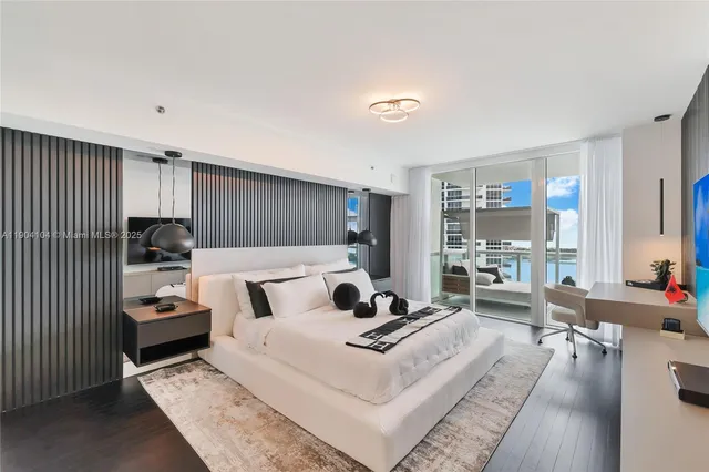 a bedroom with a bed and a large window