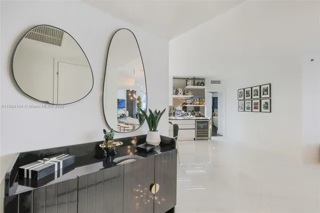 a kitchen with stainless steel appliances a stove a chimney a sink and cabinets