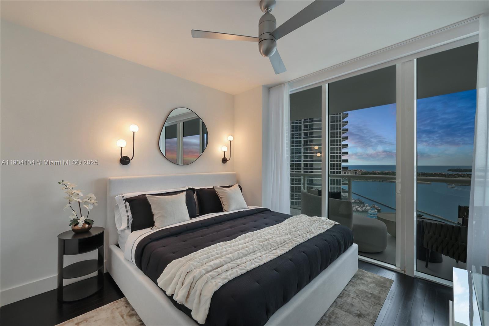 450 Alton Road, Unit 2603 Miami Beach, FL 33139 - Photo 24 of 64 a bedroom with a bed and a mirror