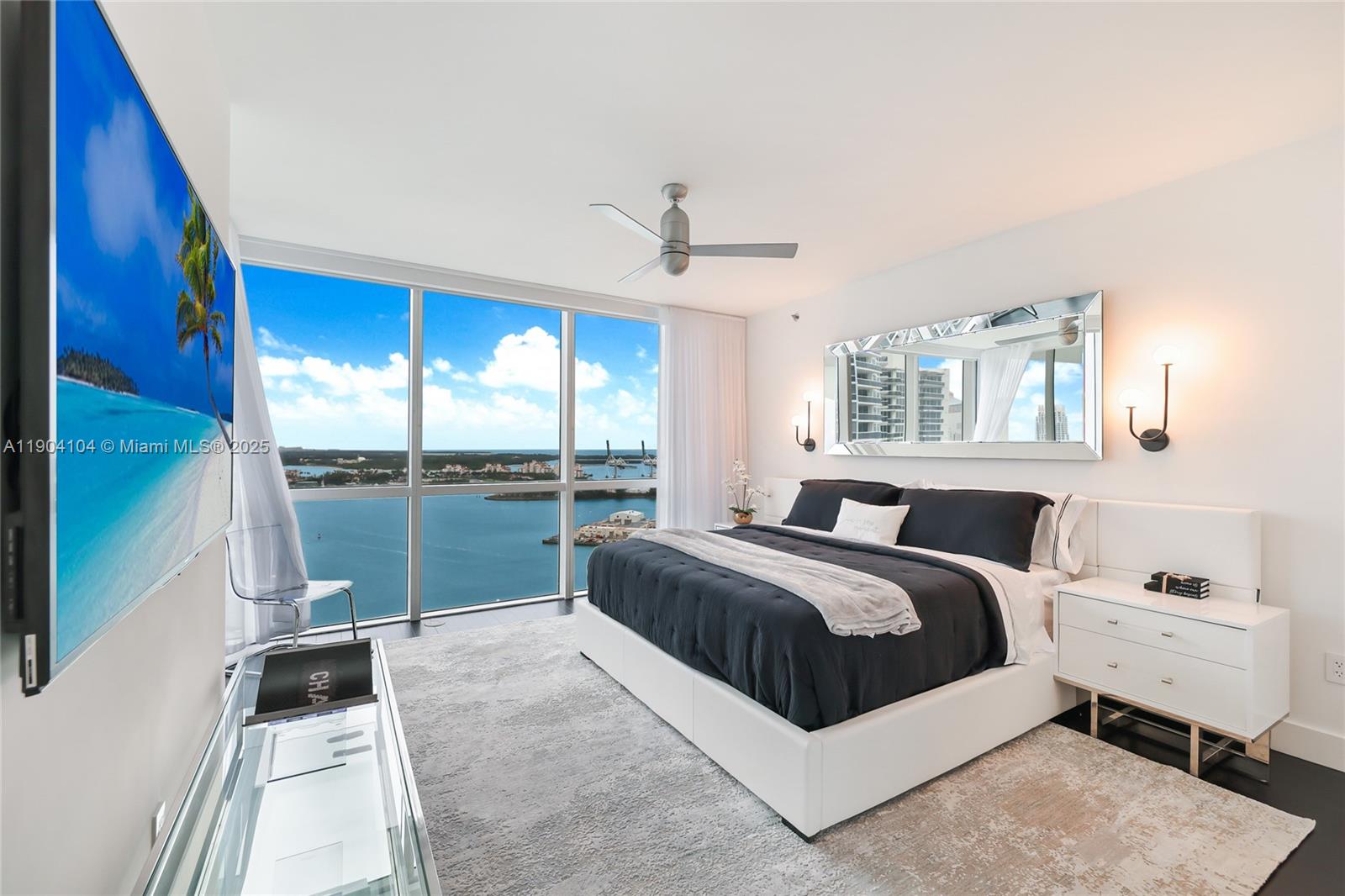 450 Alton Road, Unit 2603 Miami Beach, FL 33139 - Photo 27 of 64 a bedroom with a bed and large window with balcony view