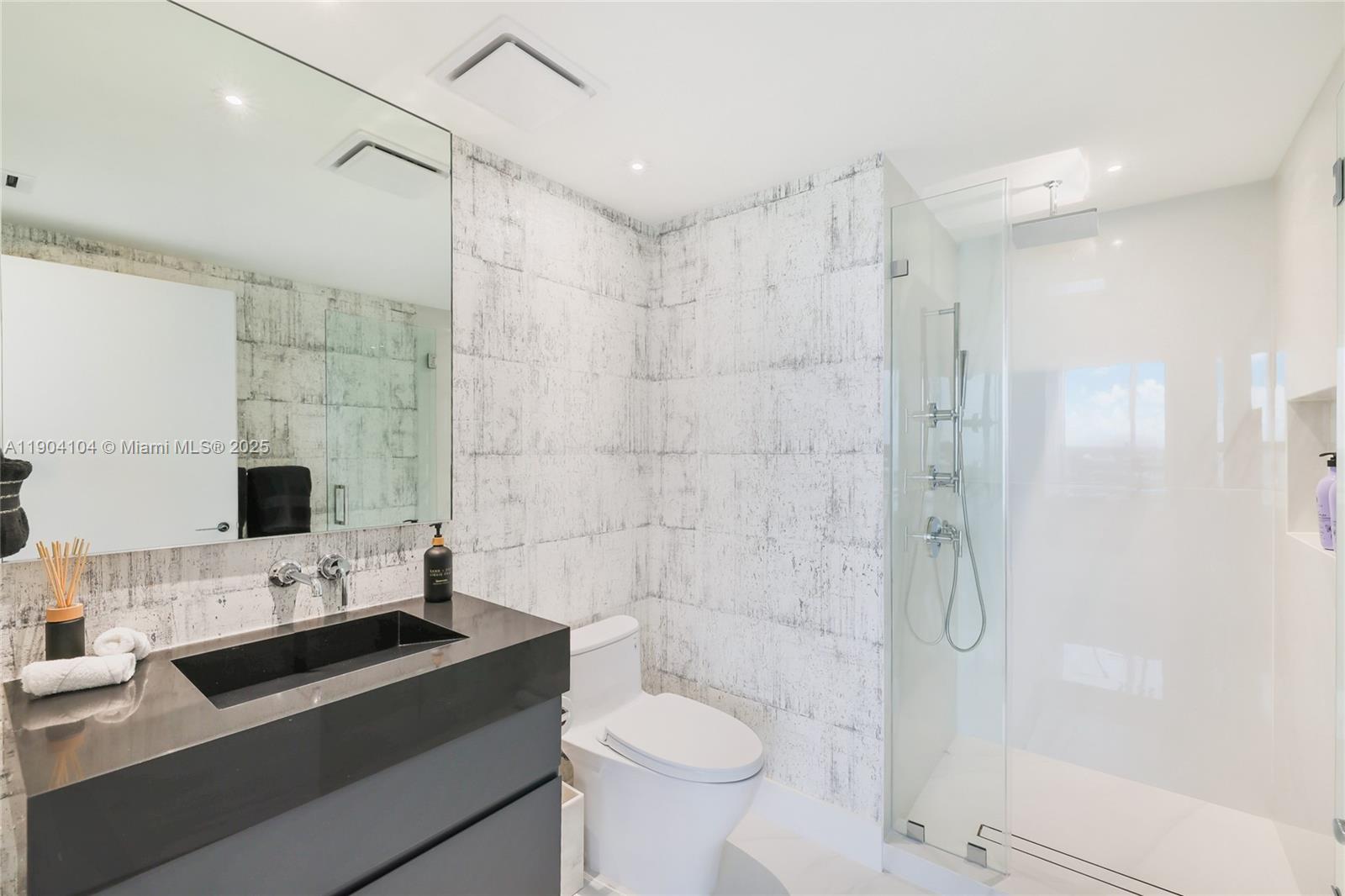 450 Alton Road, Unit 2603 Miami Beach, FL 33139 - Photo 30 of 64 a bathroom with a sink toilet and shower