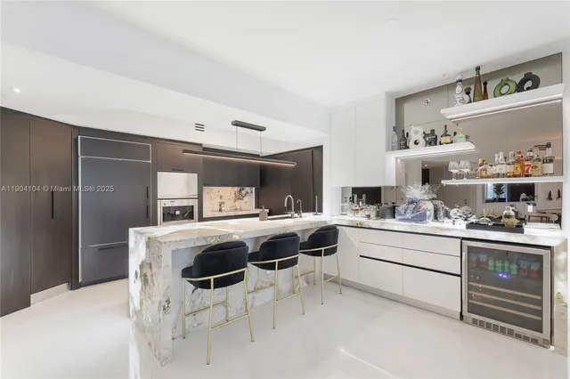 a kitchen with stainless steel appliances granite countertop a sink a stove and a refrigerator