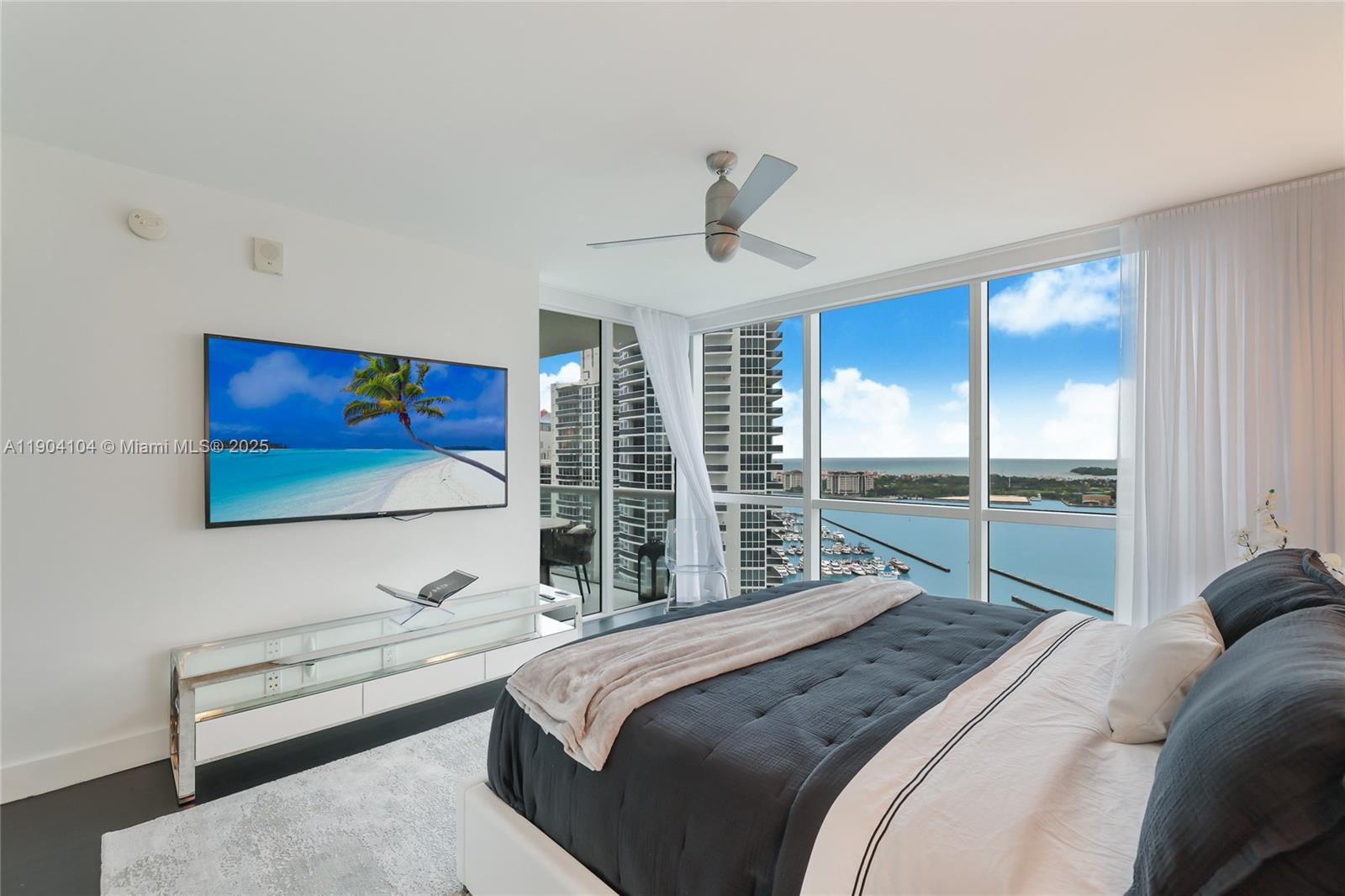 450 Alton Road, Unit 2603 Miami Beach, FL 33139 - Photo 31 of 64 a bedroom with a large bed and a large window