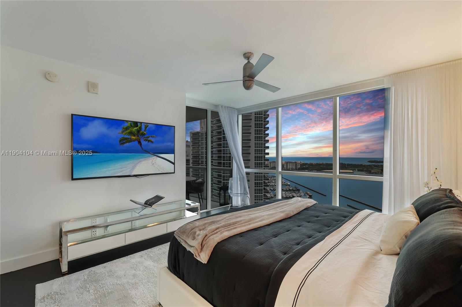 450 Alton Road, Unit 2603 Miami Beach, FL 33139 - Photo 32 of 64 a bedroom with a bed and a dresser next to a window