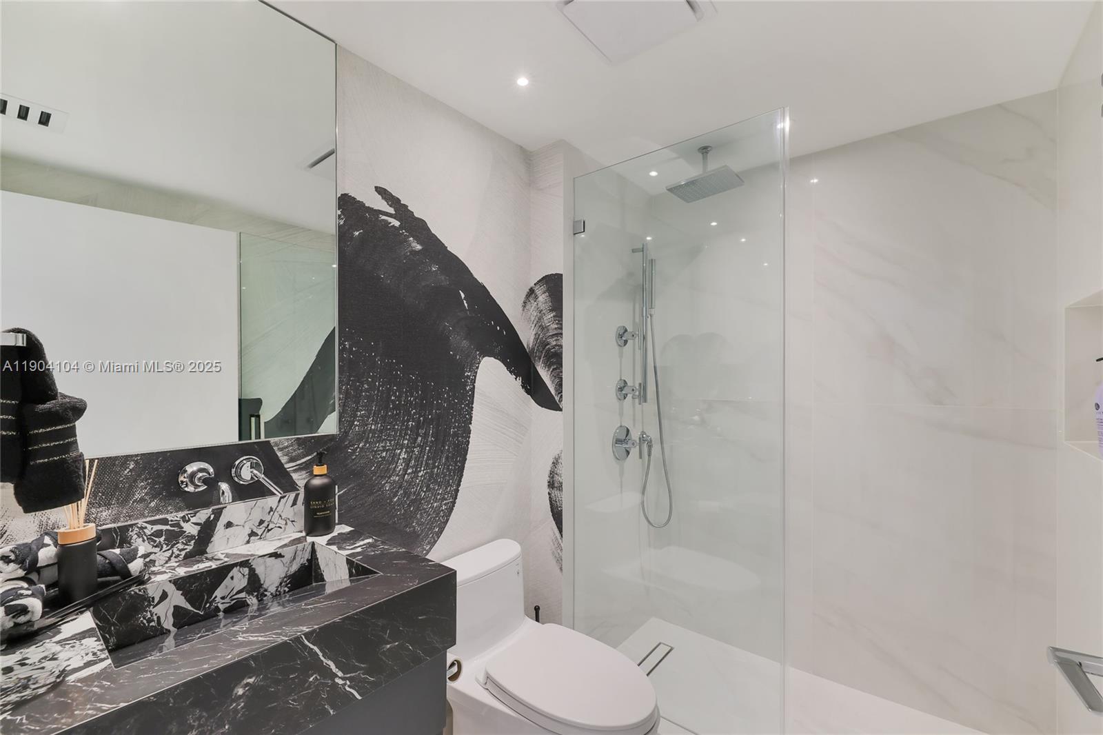 450 Alton Road, Unit 2603 Miami Beach, FL 33139 - Photo 33 of 64 a bathroom with a toilet sink and shower