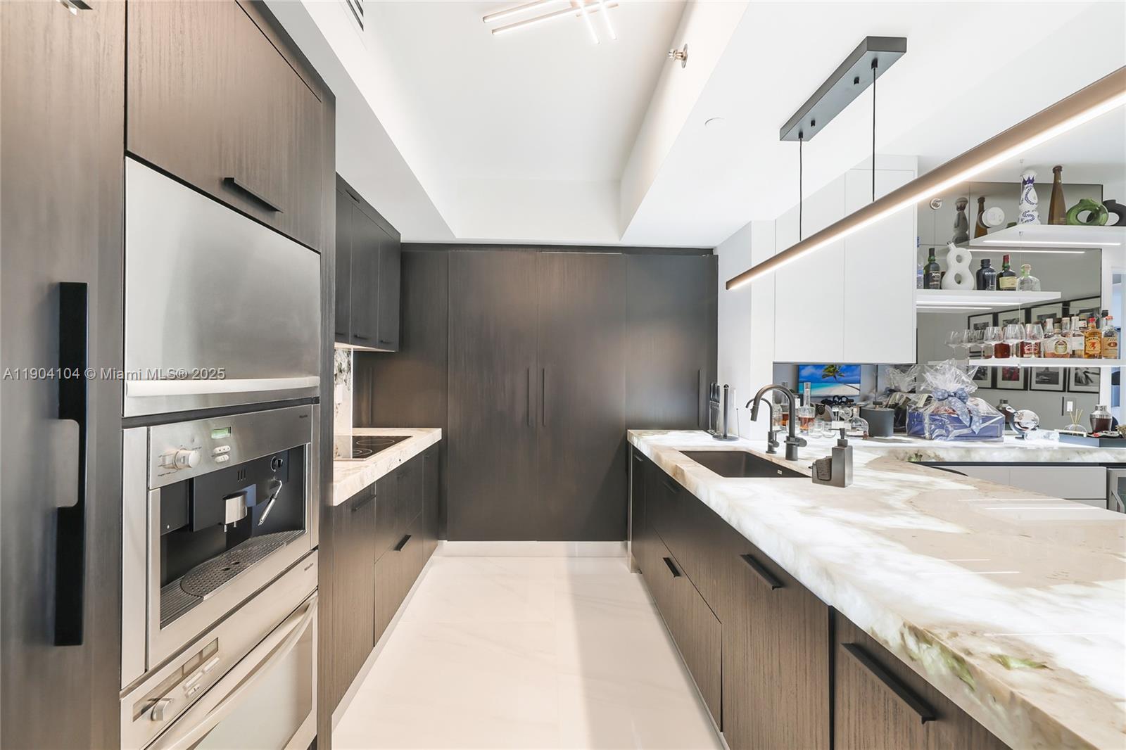450 Alton Road, Unit 2603 Miami Beach, FL 33139 - Photo 4 of 64 a kitchen with stainless steel appliances granite countertop a sink a stove and a refrigerator