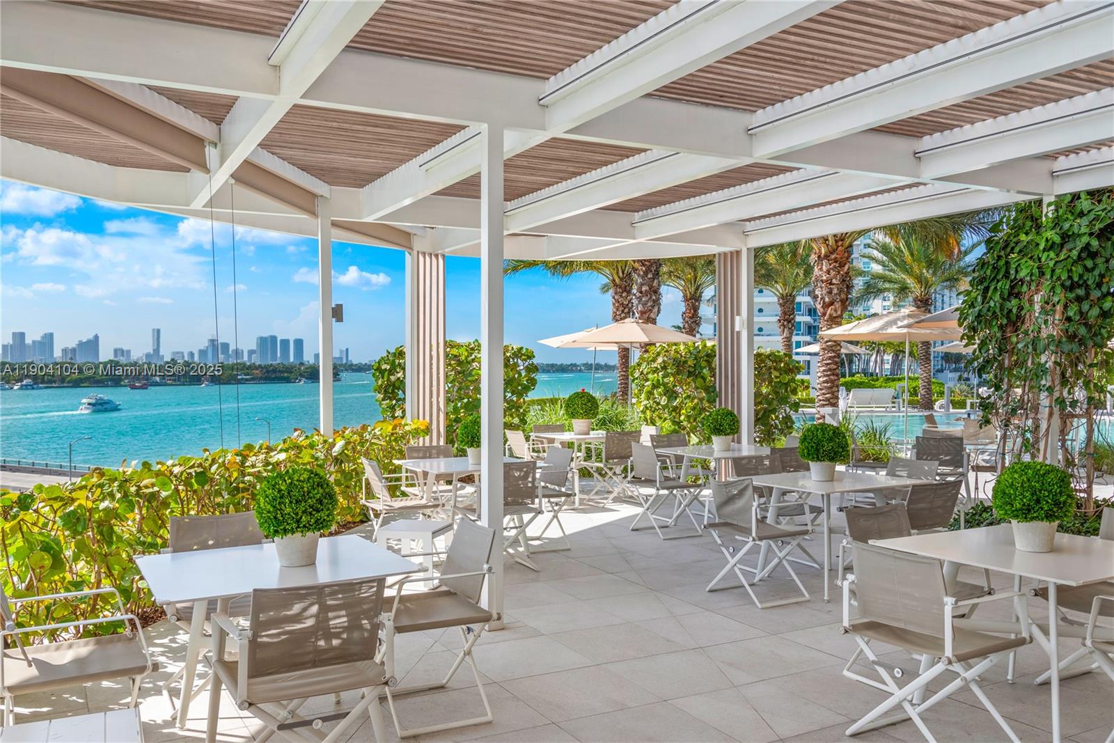 450 Alton Road, Unit 2603 Miami Beach, FL 33139 - Photo 52 of 64 a view of a patio with a table chairs and a table