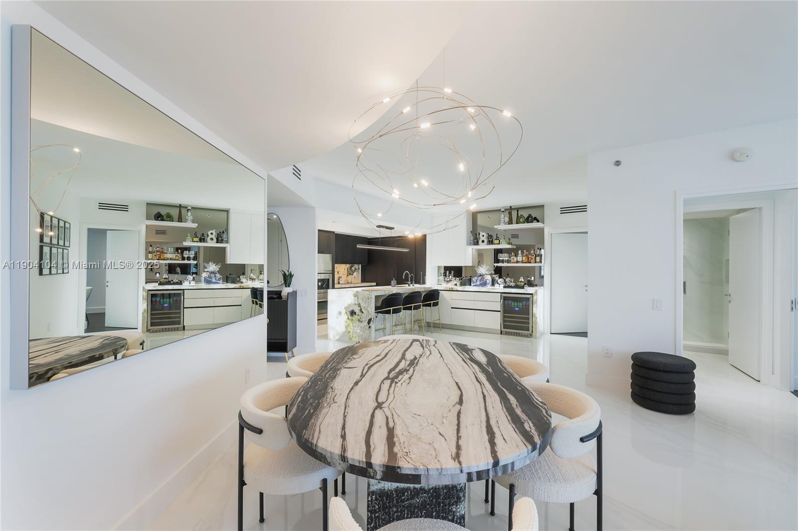 450 Alton Road, Unit 2603 Miami Beach, FL 33139 - Photo 7 of 64 a kitchen with a table and chairs in it