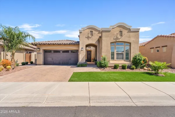 a front view of a house with a yard and a garage