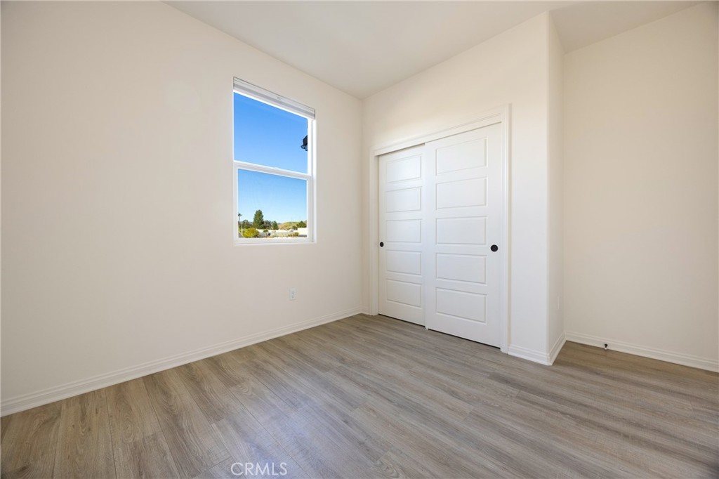 3940 Righetti Ranch Road San Luis Obispo, CA 93401 - Photo 15 of 18 a view of an empty room with wooden floor and a window