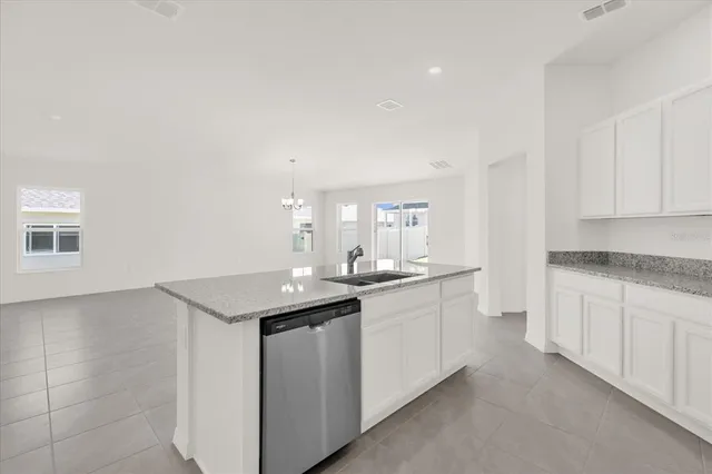 a kitchen with sink cabinets and stove