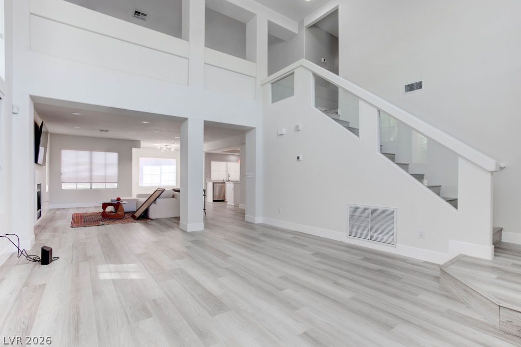 1 Rising Sun Court Henderson, NV 89074 - Photo 3 of 47 Natural light illuminates this open-concept living space with sleek flooring and a contemporary staircase.