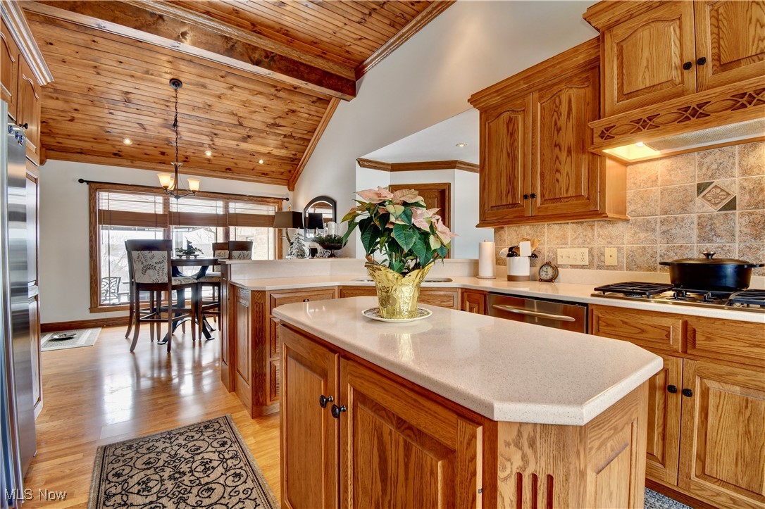 85553 Beagle Clb Road Scio, OH 43988 - Photo 15 of 50 Kitchen with a center island, decorative light fixtures, light countertops, decorative backsplash, and wood ceiling