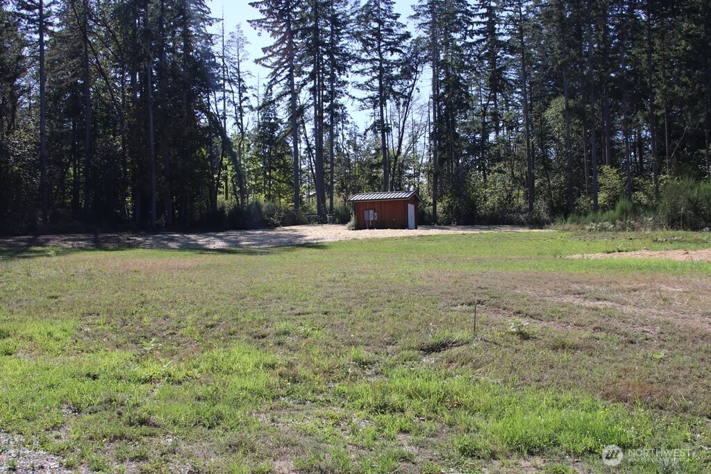 24345 Wax Orchard Road Southwest Vashon, WA 98070 - Photo 16 of 17 a view of a field with trees in the background