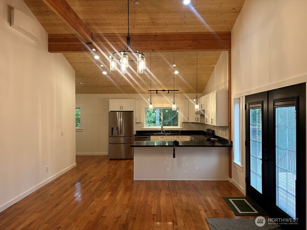 24345 Wax Orchard Road Southwest Vashon, WA 98070 - Photo 4 of 17 a view of a room with wooden floor and furniture