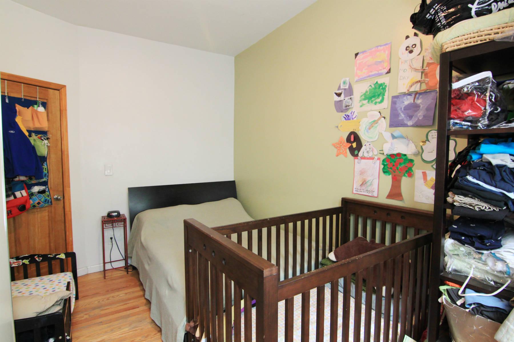 a view of kids room with toys and wooden floor