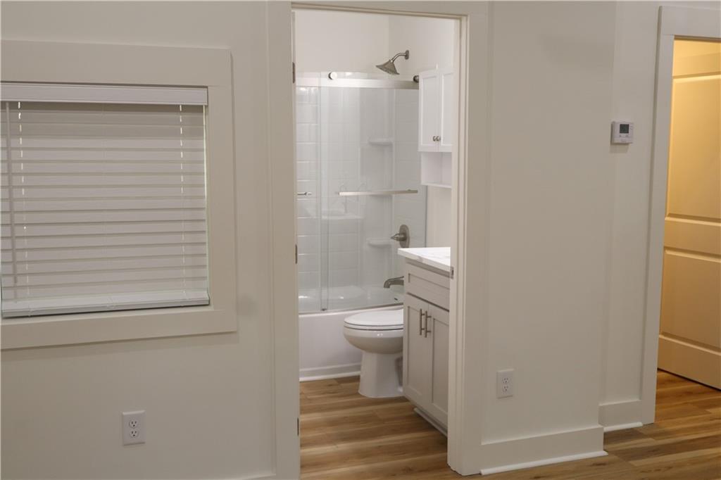 5120 Railroad Avenue Flowery Branch, GA 30542 - Photo 11 of 34 a bathroom with a toilet and a shower