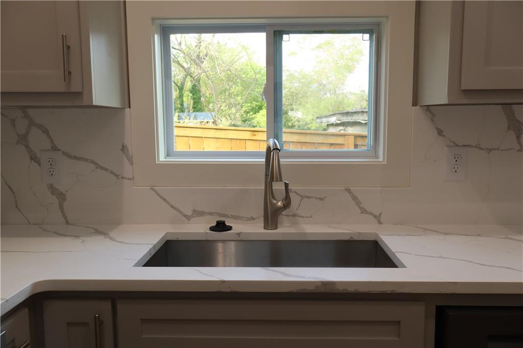 5120 Railroad Avenue Flowery Branch, GA 30542 - Photo 17 of 34 a view of a sink a counter top space and cabinets