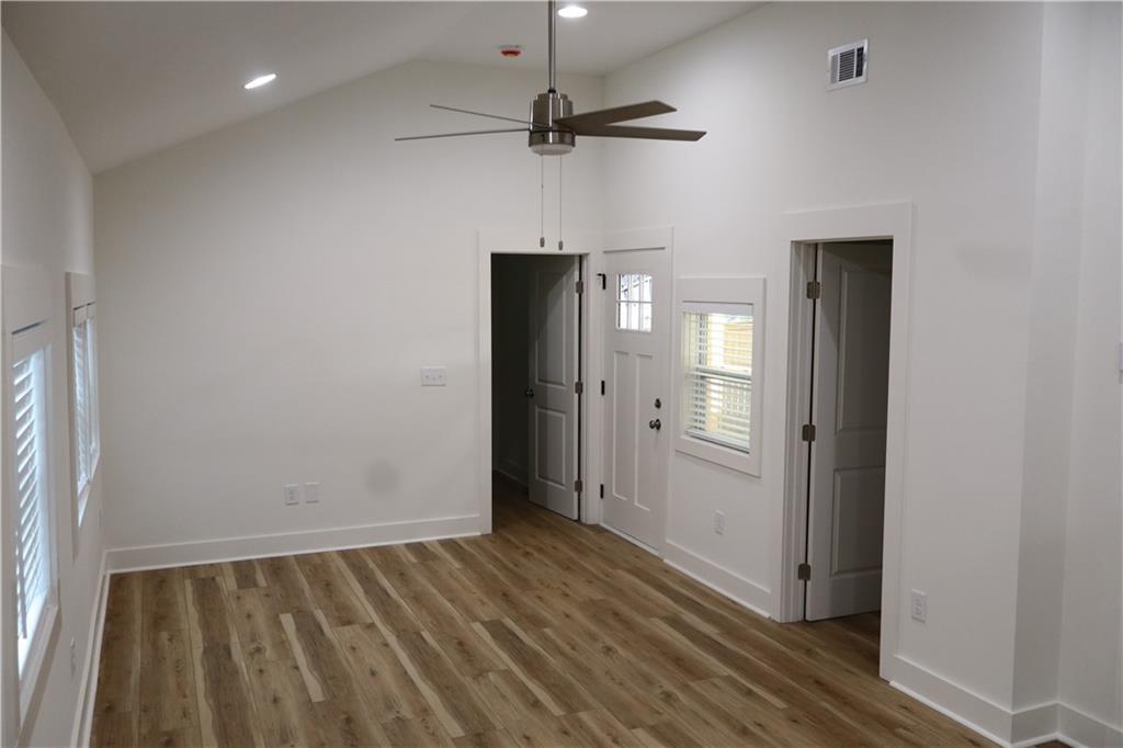 5120 Railroad Avenue Flowery Branch, GA 30542 - Photo 18 of 34 a view of a hallway with wooden floor and a chandelier fan