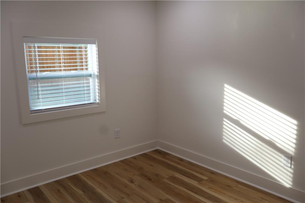 5120 Railroad Avenue Flowery Branch, GA 30542 - Photo 19 of 34 a view of an empty room with wooden floor and a window