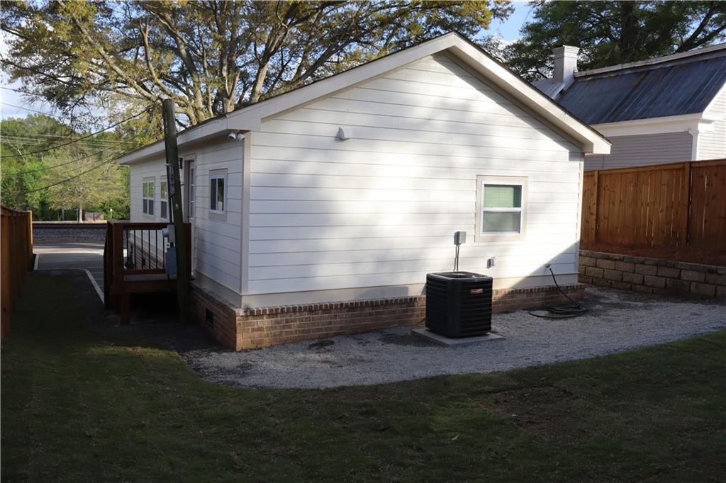 5120 Railroad Avenue Flowery Branch, GA 30542 - Photo 24 of 34 a view of backyard of house and wooden deck