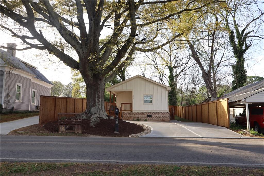 5120 Railroad Avenue Flowery Branch, GA 30542 - Photo 27 of 34 a view of a house with a yard