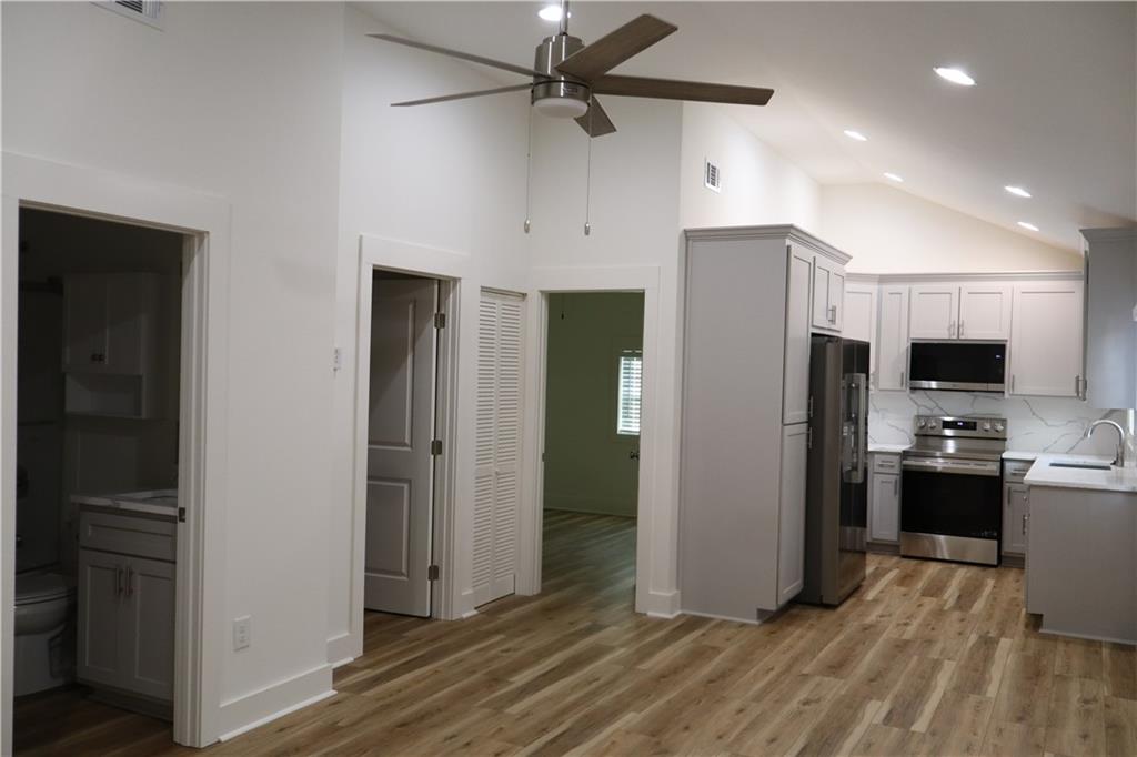 5120 Railroad Avenue Flowery Branch, GA 30542 - Photo 8 of 34 a view of a kitchen with refrigerator and wooden floor