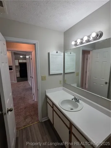 a bathroom with a sink a mirror and a shower