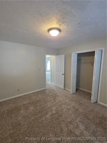 a view of an empty room and a ceiling fan