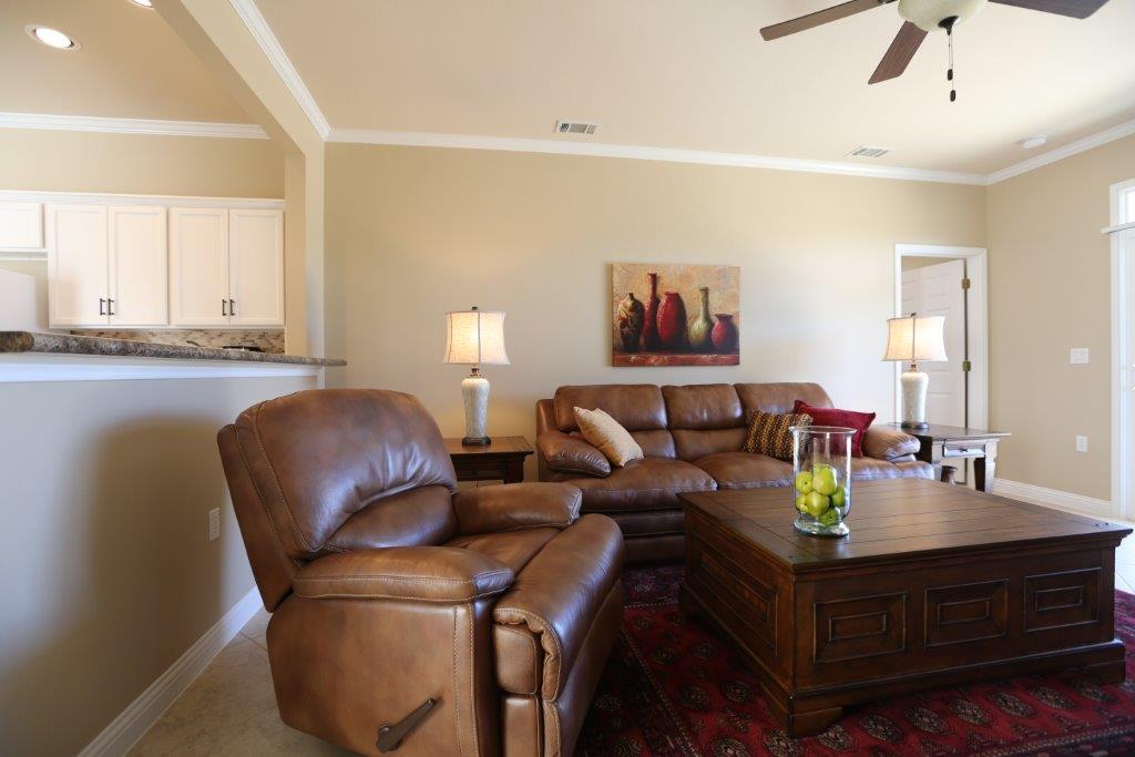 109 Ranier Lane Georgetown, TX 78633 - Photo 6 of 18 Comfortable living area offers a warm and inviting atmosphere with neutral tones and classic trim.