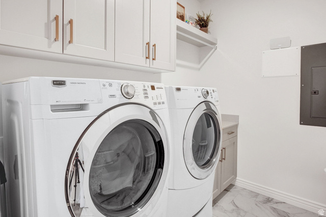 910 South 1700 West Layton, UT 84041 - Photo 20 of 26 Laundry room featuring electric panel, washing machine and clothes dryer, cabinet space, and light marble finish flooring