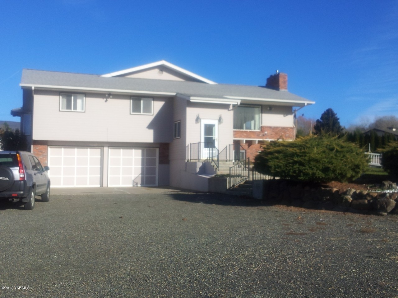 7303 Bittner Road Yakima, WA 98901 - Photo 1 of 38 a front view of a house with a garden