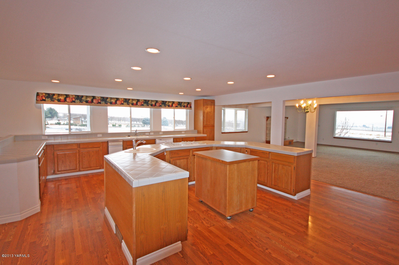 7303 Bittner Road Yakima, WA 98901 - Photo 14 of 38 a kitchen with stainless steel appliances granite countertop a stove a sink and a refrigerator