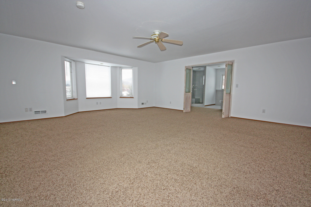 7303 Bittner Road Yakima, WA 98901 - Photo 21 of 38 a view of a big room with windows and chandelier fan