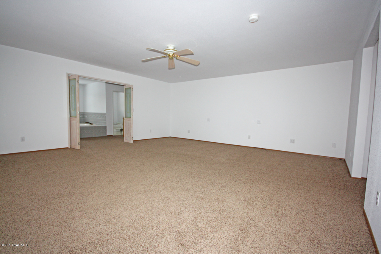 7303 Bittner Road Yakima, WA 98901 - Photo 22 of 38 a view of an empty room with a chandelier fan