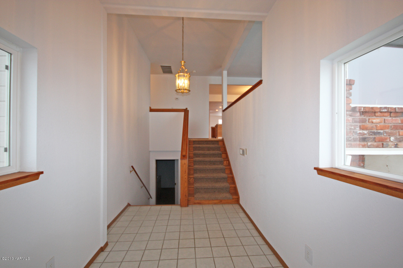 7303 Bittner Road Yakima, WA 98901 - Photo 8 of 38 a view of a hallway with wooden floor and staircase