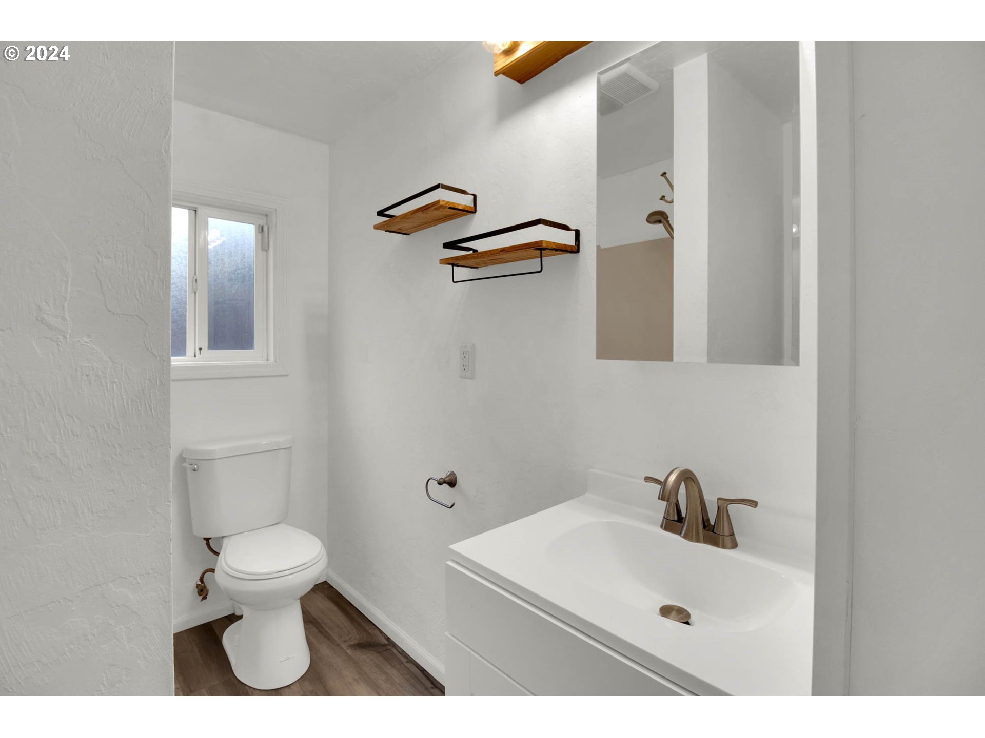 2224 Ohio Street Eugene, OR 97402 - Photo 13 of 31 a bathroom with a sink a toilet and mirror