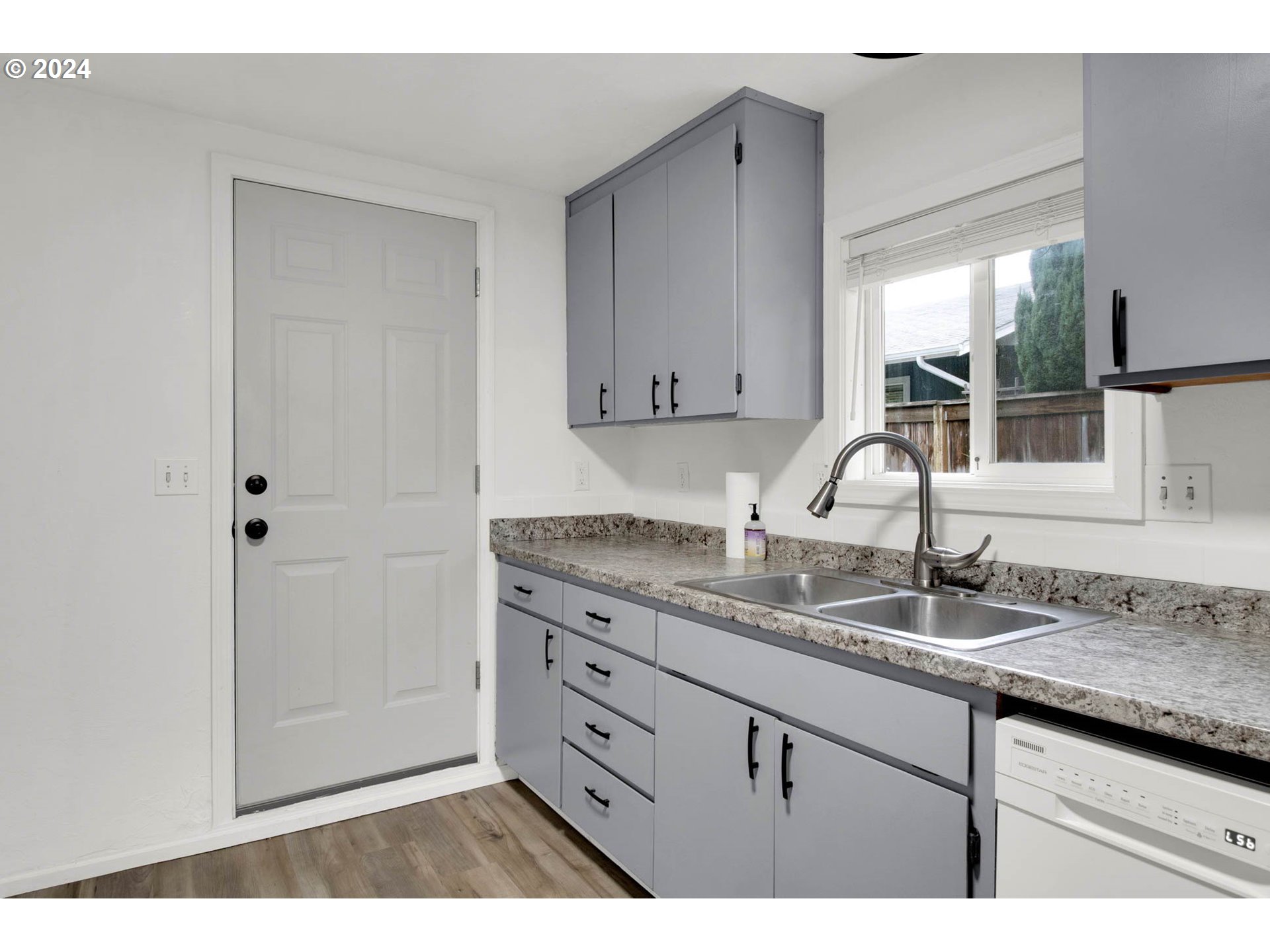 2224 Ohio Street Eugene, OR 97402 - Photo 18 of 31 a kitchen with a sink and a wooden cabinets