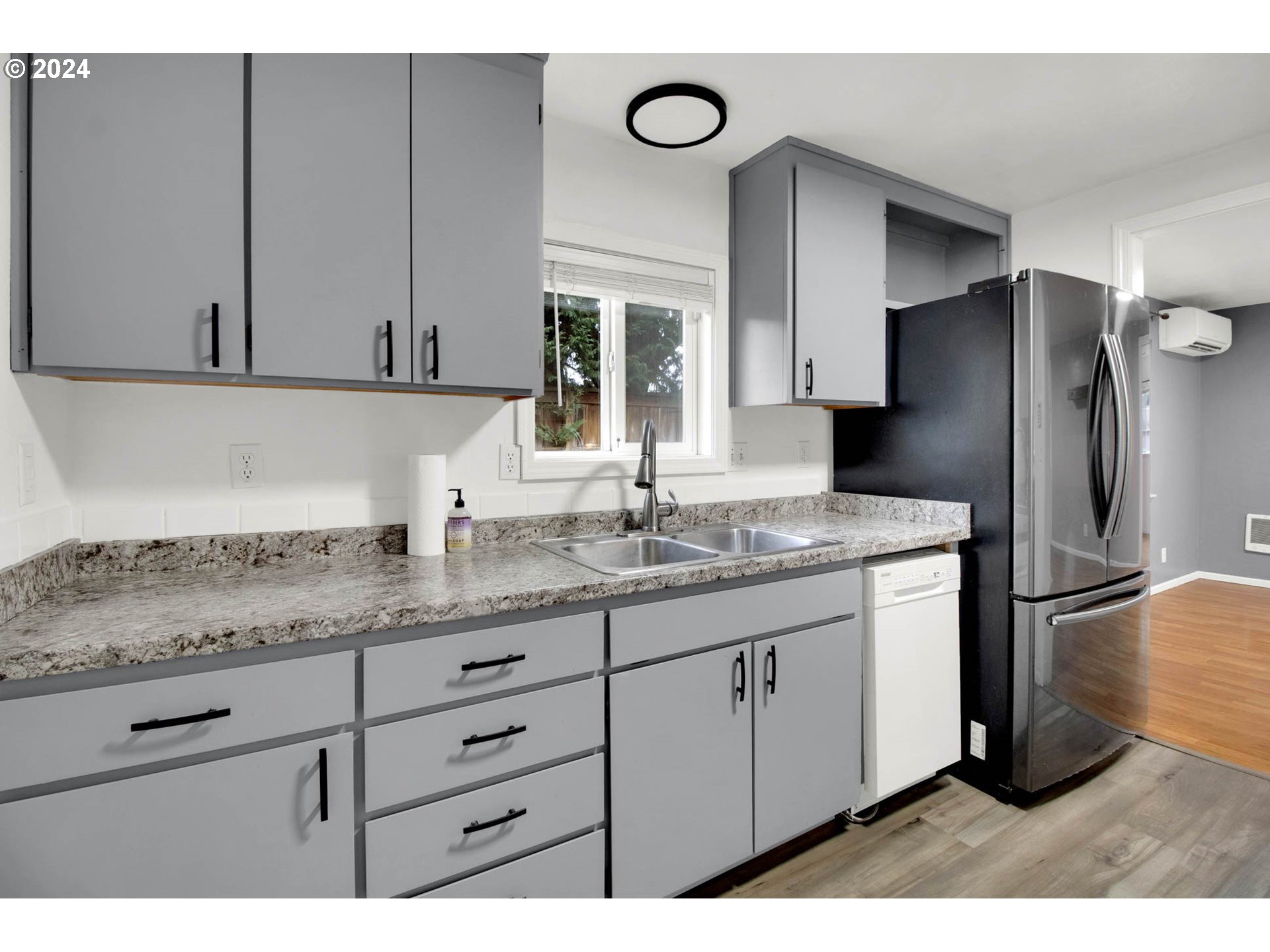 2224 Ohio Street Eugene, OR 97402 - Photo 19 of 31 a kitchen with stainless steel appliances granite countertop a sink a refrigerator and a granite counter tops