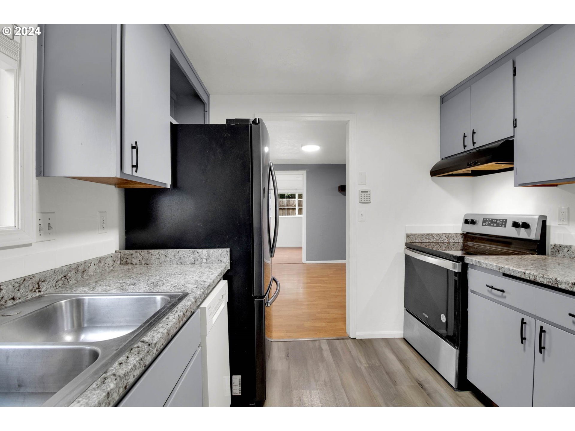 2224 Ohio Street Eugene, OR 97402 - Photo 20 of 31 a kitchen with stainless steel appliances granite countertop a sink a stove and a refrigerator with wooden cabinets
