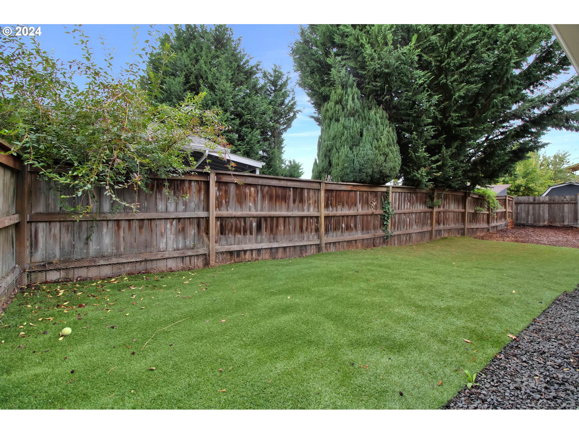 2224 Ohio Street Eugene, OR 97402 - Photo 27 of 31 a view of a backyard with a wooden fence