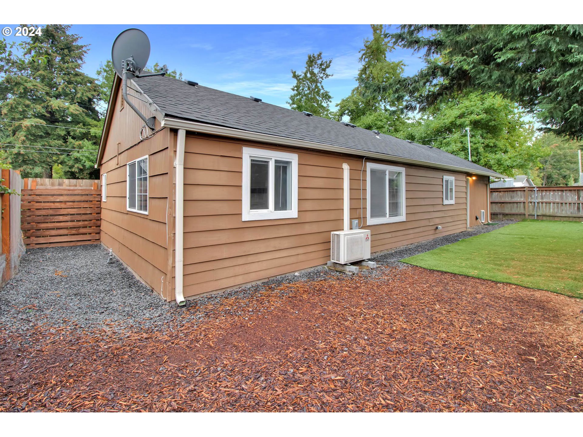 2224 Ohio Street Eugene, OR 97402 - Photo 29 of 31 a backyard of a house with plants and large tree
