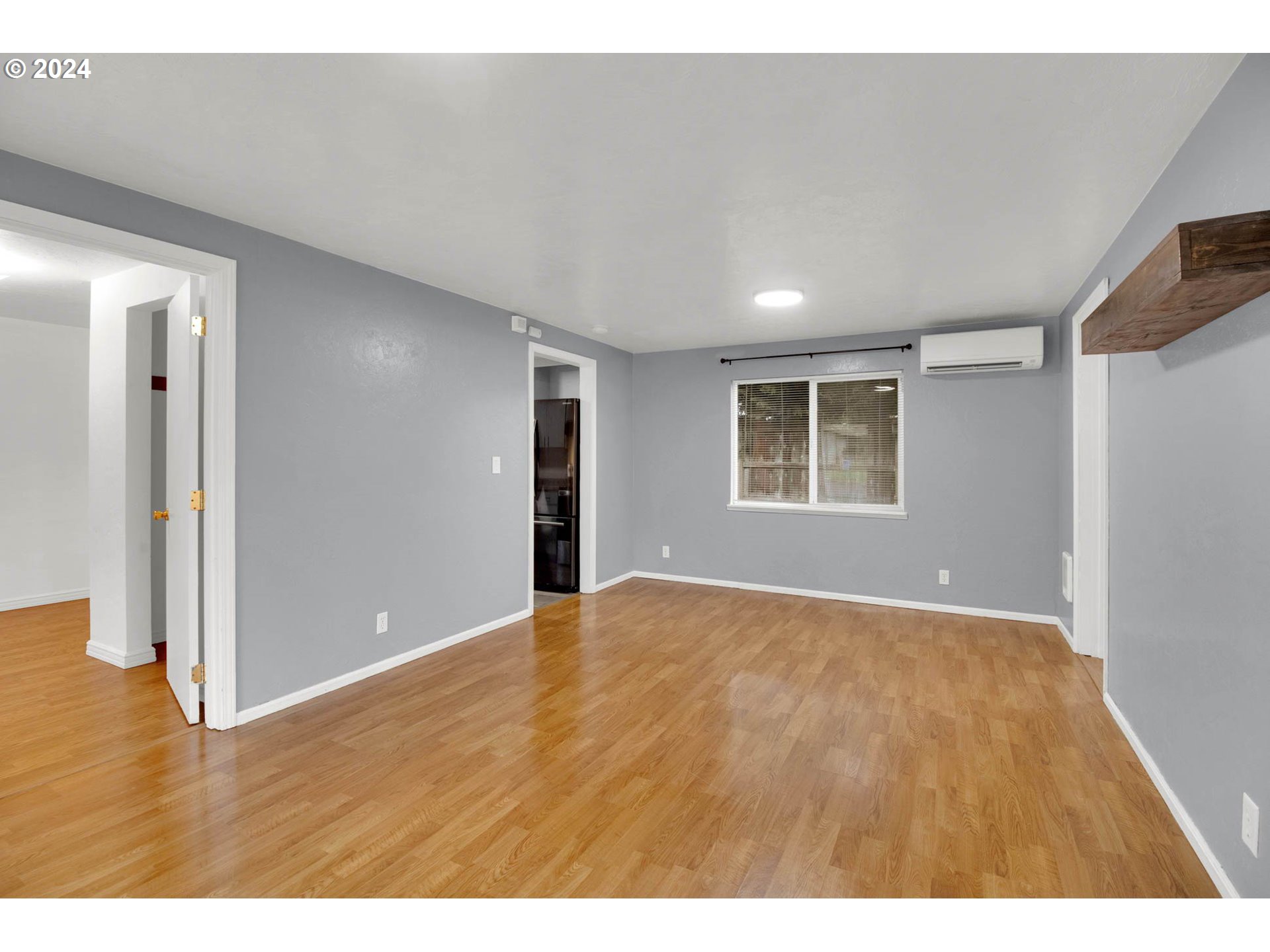 2224 Ohio Street Eugene, OR 97402 - Photo 6 of 31 a view of an empty room with wooden floor and a window