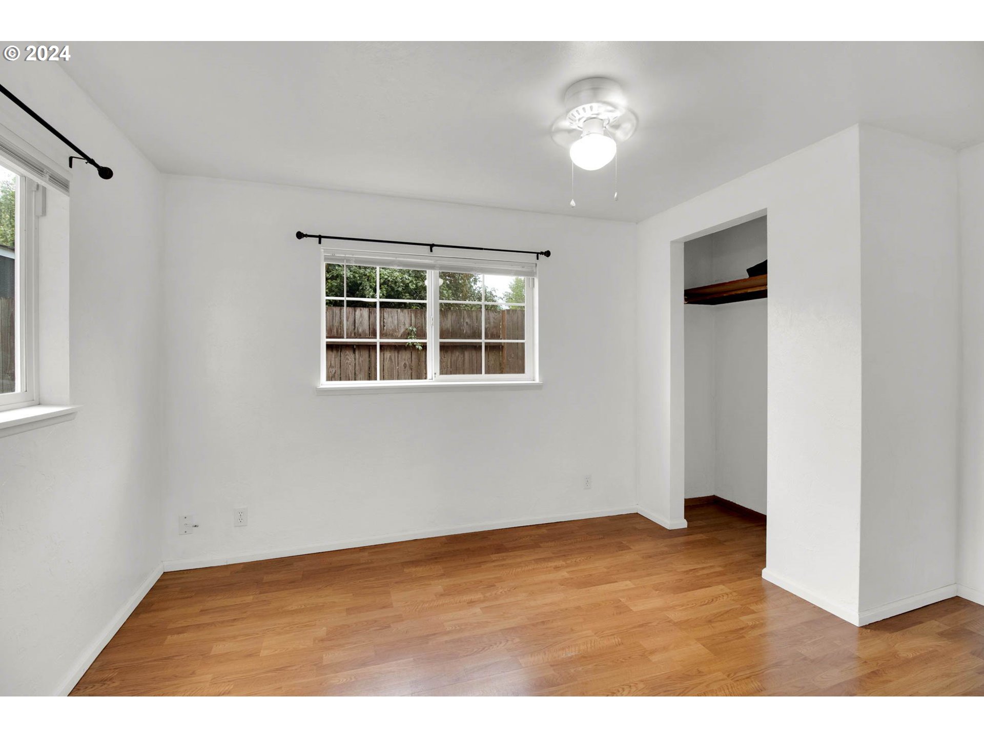 2224 Ohio Street Eugene, OR 97402 - Photo 8 of 31 an empty room with wooden floor and windows