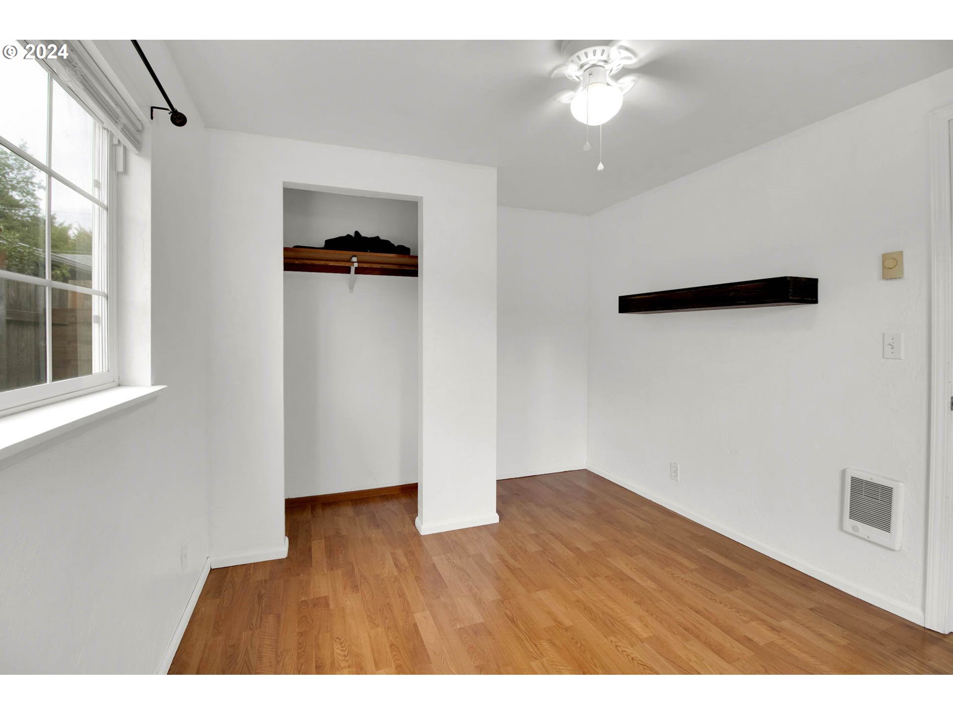 2224 Ohio Street Eugene, OR 97402 - Photo 9 of 31 an empty room with wooden floor and cabinet
