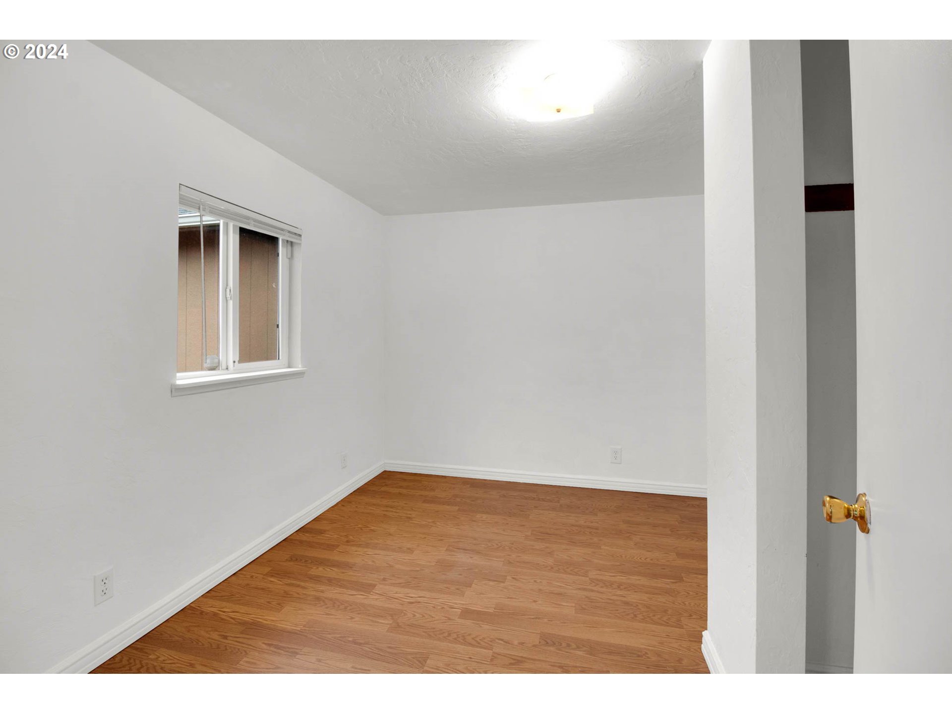 2224 Ohio Street Eugene, OR 97402 - Photo 10 of 31 a view of an empty room with wooden floor