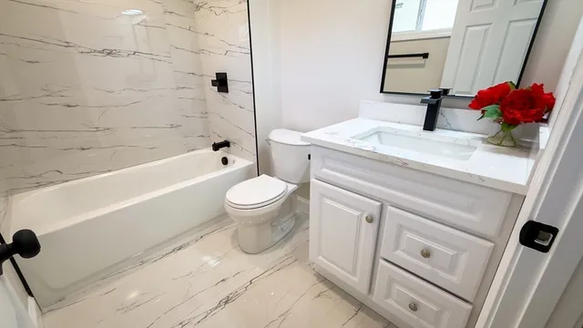 a bathroom with a sink toilet and shower