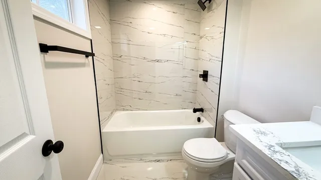 a bathroom with a toilet and a shower