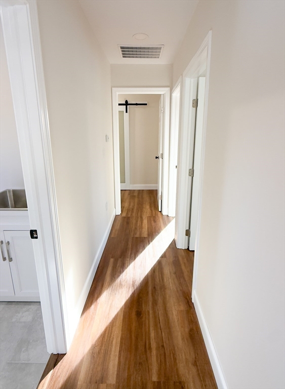 122 Copperfield Road Worcester, MA 01602 - Photo 18 of 28 a view of a hallway with wooden floor and staircase
