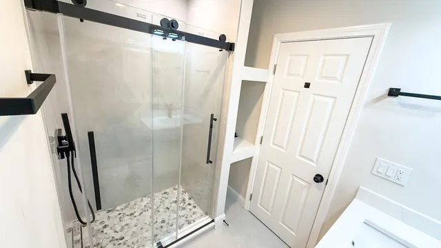 a bathroom with a shower and a sink
